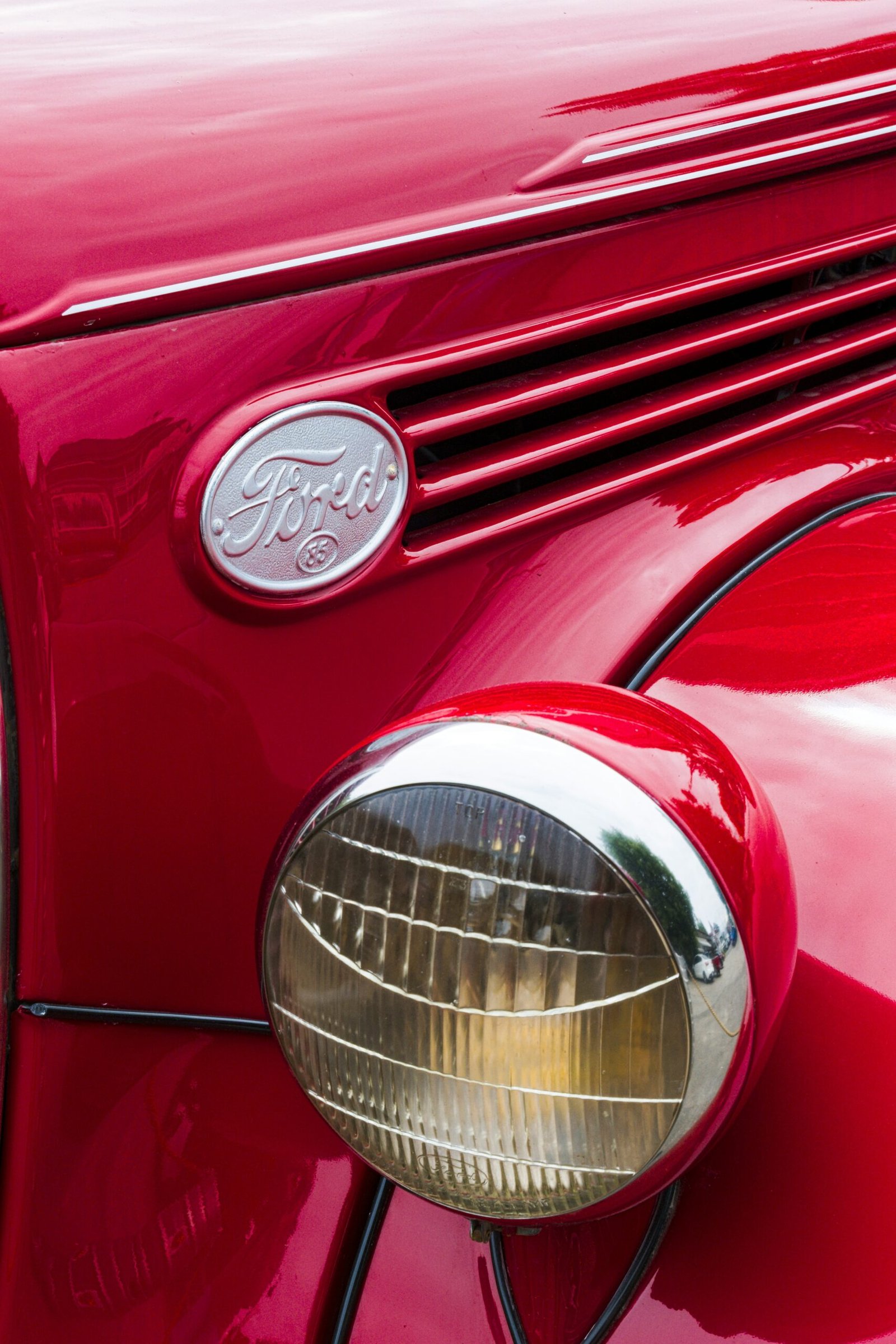 a close up of the front end of a red car